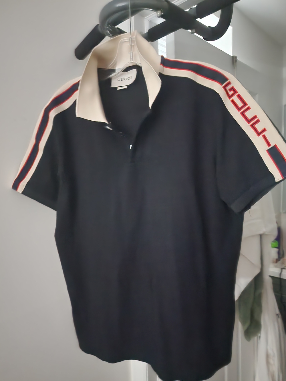 Black Polo with Cream Collar and Red-Blue Shoulder Stripes. S-M